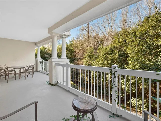 a view of a chairs and table in the balcony