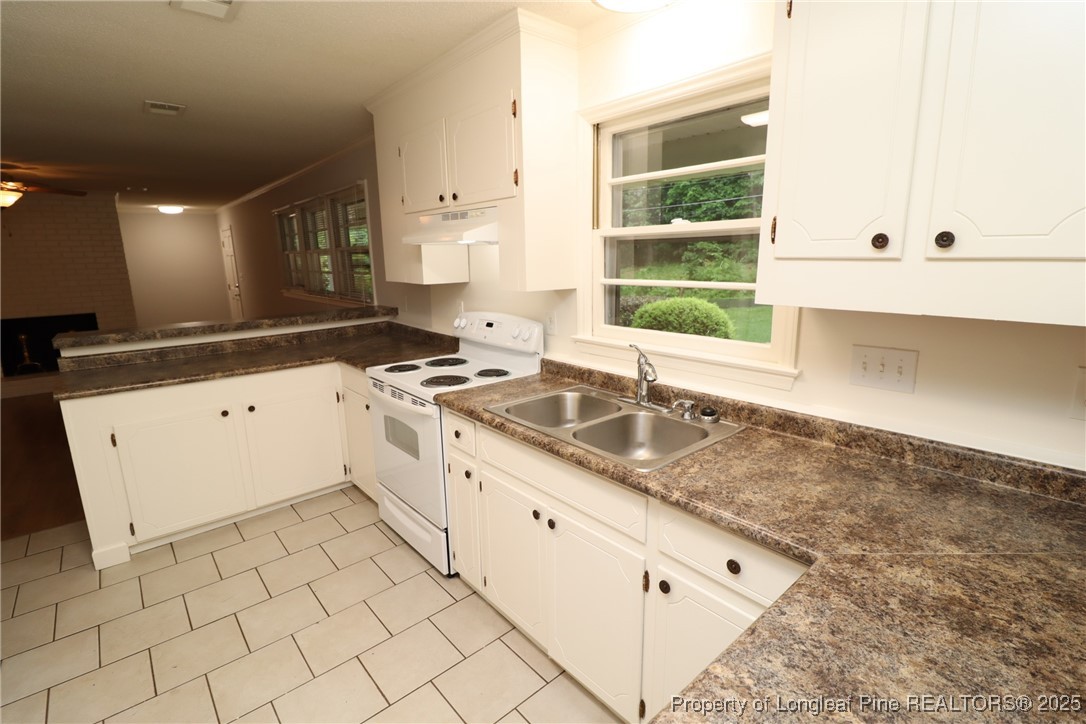 1426 Trinity Circle Raleigh, NC 27607 - Photo 11 of 31 a kitchen with granite countertop white cabinets and white appliances