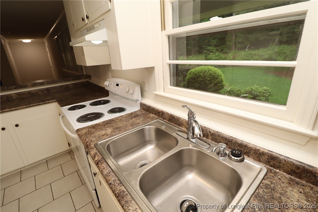 1426 Trinity Circle Raleigh, NC 27607 - Photo 13 of 31 a kitchen with a sink and a stove top oven