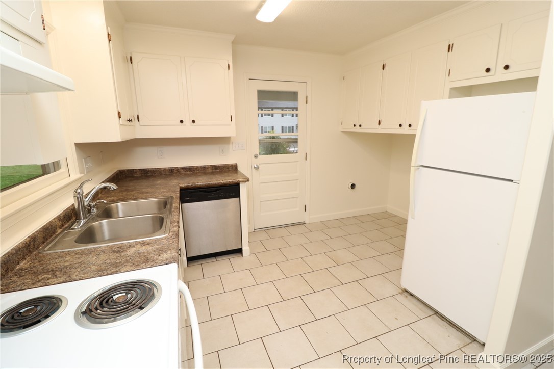 1426 Trinity Circle Raleigh, NC 27607 - Photo 15 of 31 a kitchen with a refrigerator sink stove and cabinets