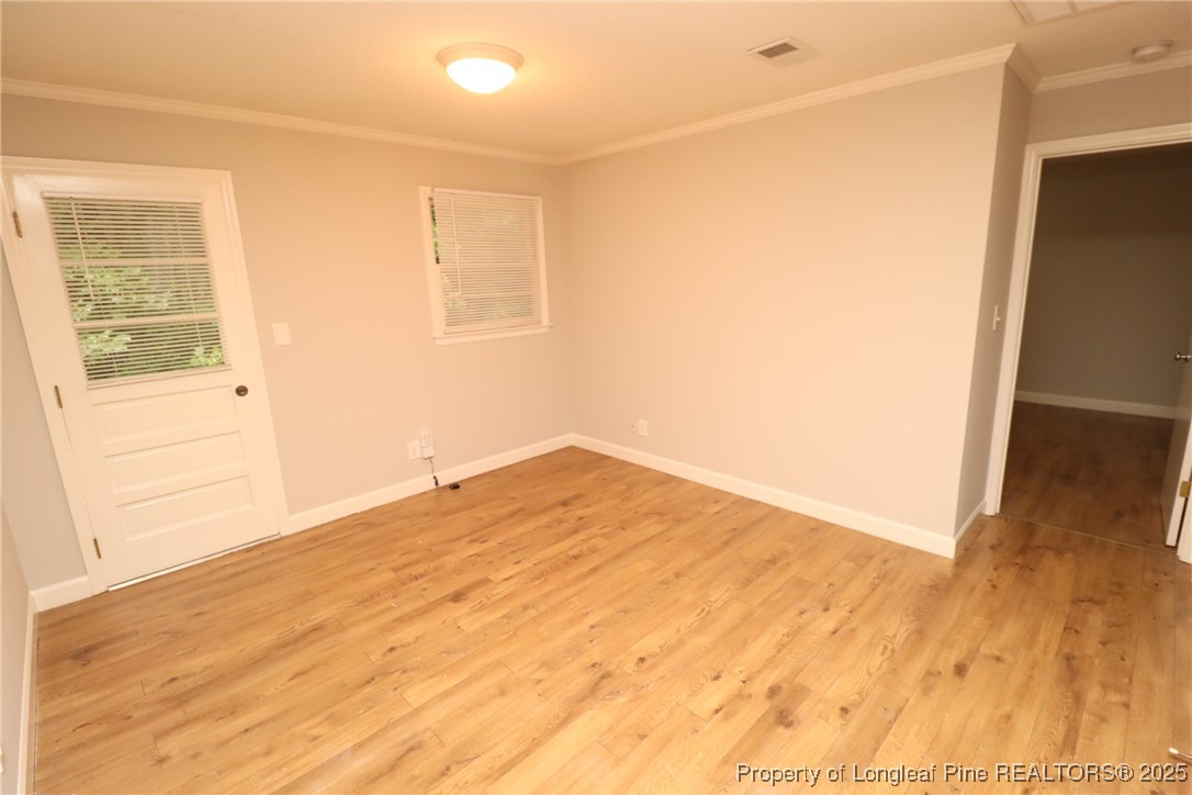 1426 Trinity Circle Raleigh, NC 27607 - Photo 16 of 31 a view of empty room with wooden floor