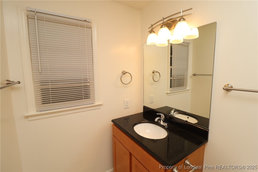 1426 Trinity Circle Raleigh, NC 27607 - Photo 23 of 31 a bathroom with a sink and a mirror