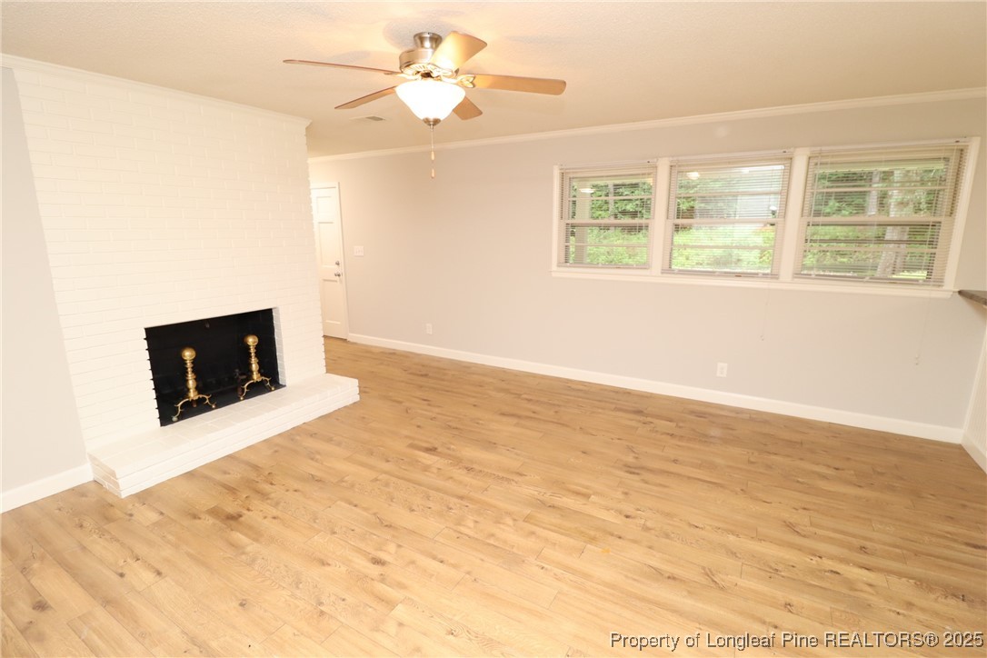 1426 Trinity Circle Raleigh, NC 27607 - Photo 6 of 31 a view of an empty room with a fireplace and a window
