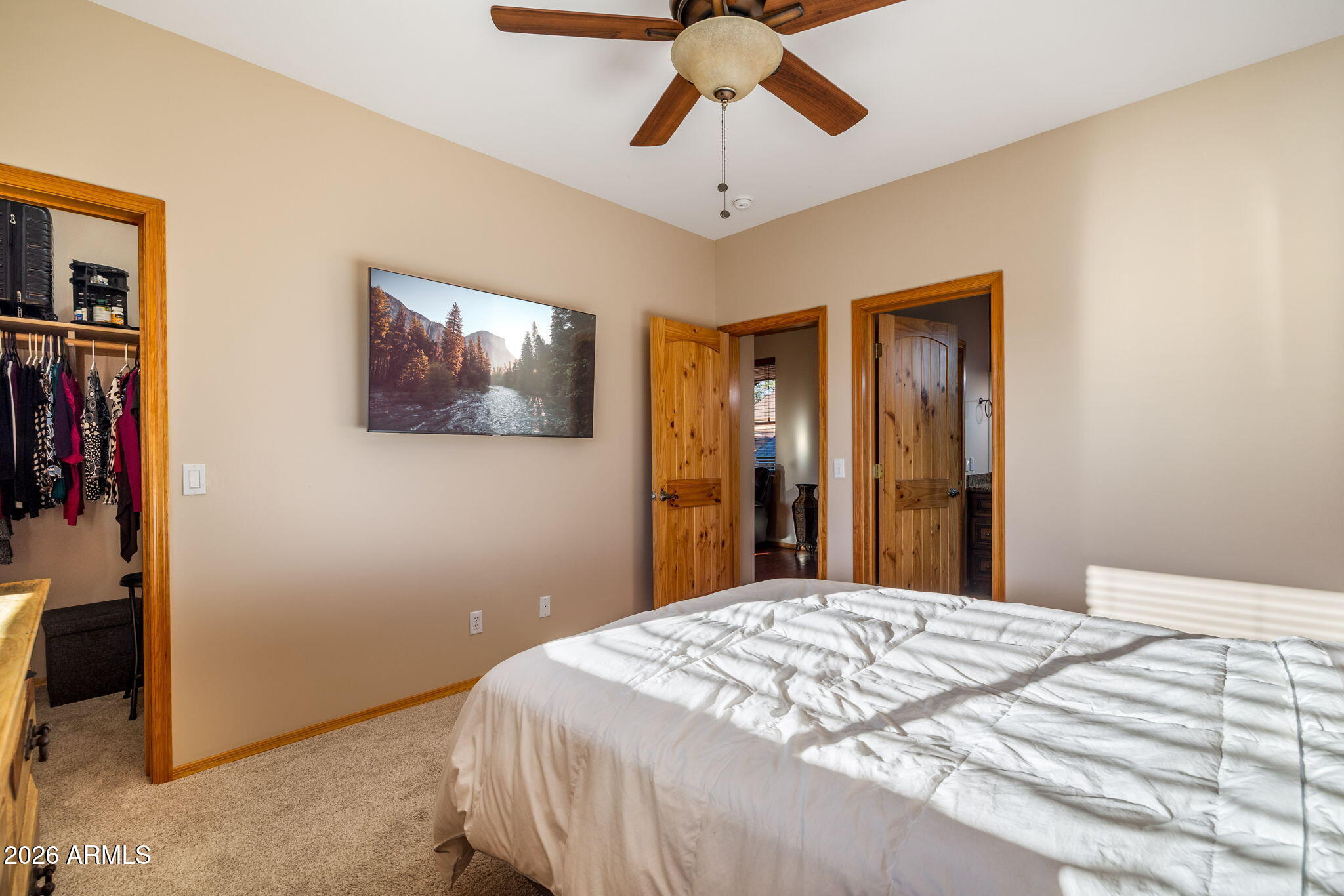 2868 South Meadow Road Heber, AZ 85928 - Photo 27 of 63 a bedroom with a bed and a chandelier