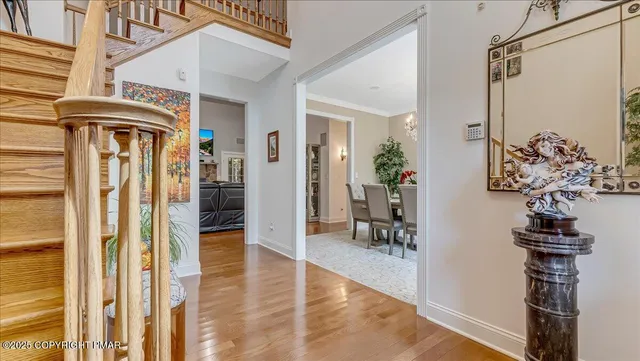 a kitchen with stainless steel appliances granite countertop a stove a refrigerator a oven a sink a dining table and chairs with wooden floor