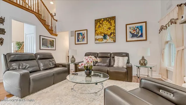 a kitchen with stainless steel appliances granite countertop a stove top oven a sink dishwasher and white cabinets with wooden floor