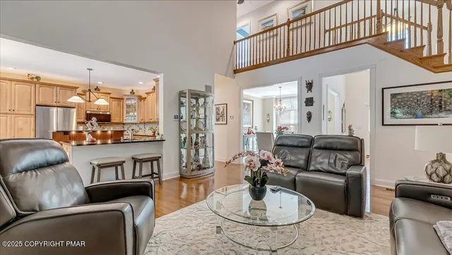 a view of a dining room with furniture and a chandelier