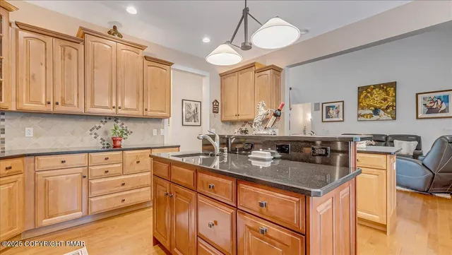 a spacious bathroom with a granite countertop sink a mirror and a toilet