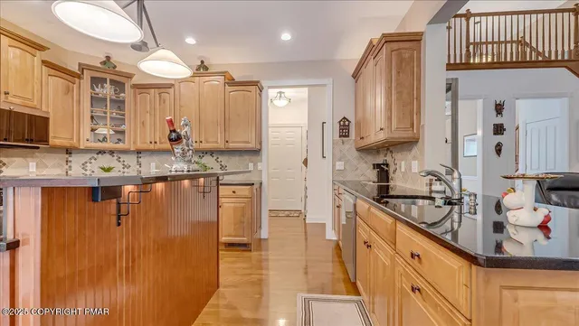 a bathroom with a granite countertop toilet a sink and a mirror