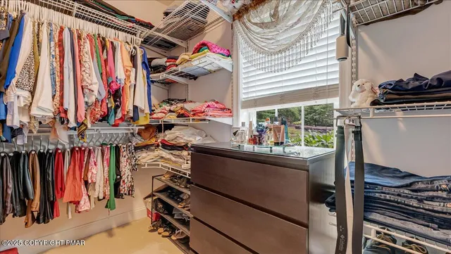 a view of a roof deck with couches and wooden floor