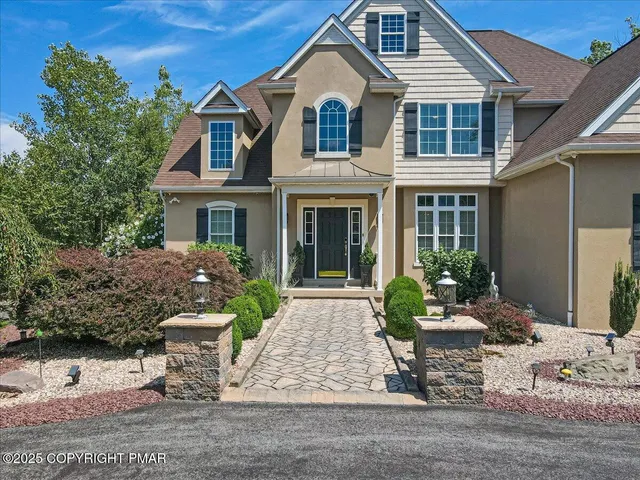 a living room with furniture fireplace and a large window