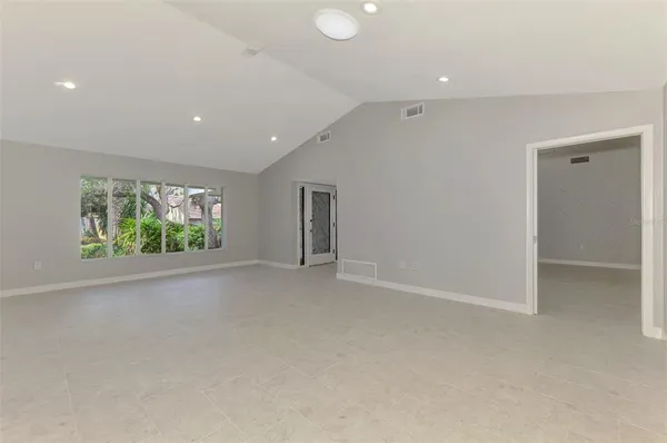 a large kitchen with kitchen island a sink stainless steel appliances and cabinets