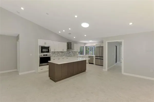 a kitchen with stainless steel appliances a stove sink microwave and cabinets