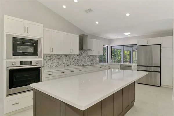 a kitchen with stainless steel appliances white cabinets and a sink
