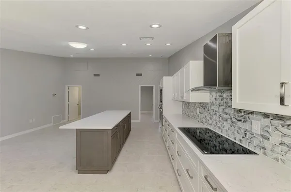 a kitchen with a stove a sink and a refrigerator