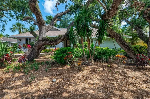 a backyard of a house with lots of green space and fountain