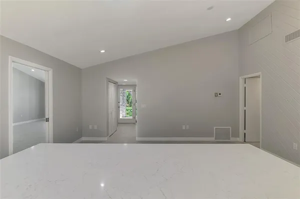 a large kitchen with stainless steel appliances a large counter top