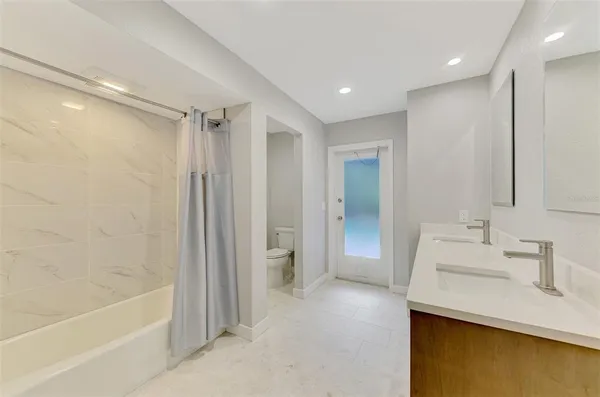 a spacious bathroom with a double vanity sink double and mirror