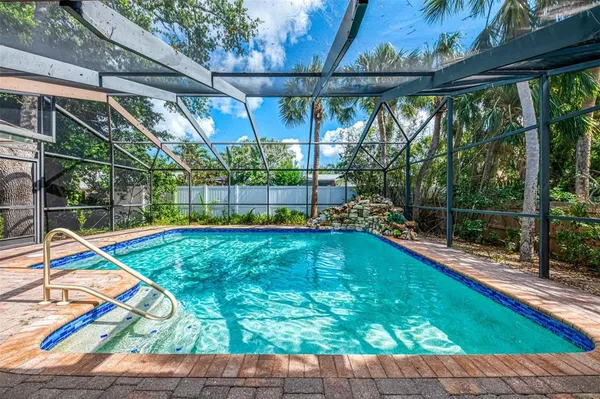 an aerial view of a house with a yard and a large tree