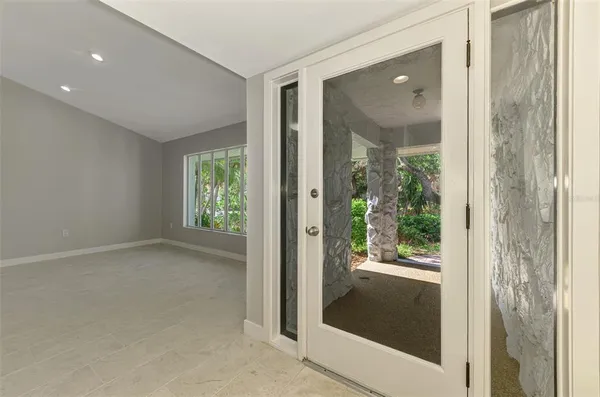 a view of hallway with a large window and front door