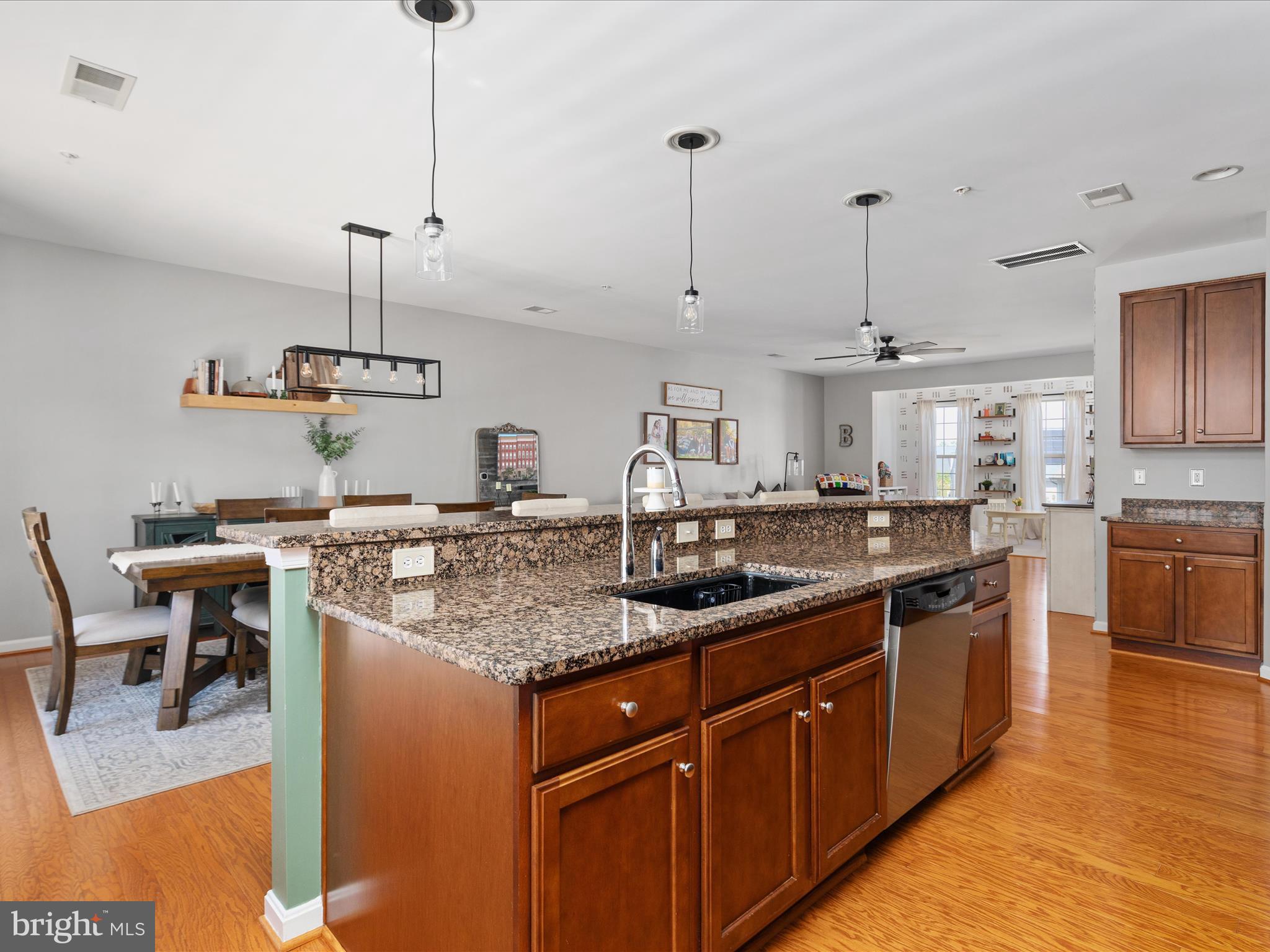 7734 Cedar Branch Drive Gainesville, VA 20155 - Photo 14 of 62 a kitchen with stainless steel appliances granite countertop a sink a stove and a wooden floors