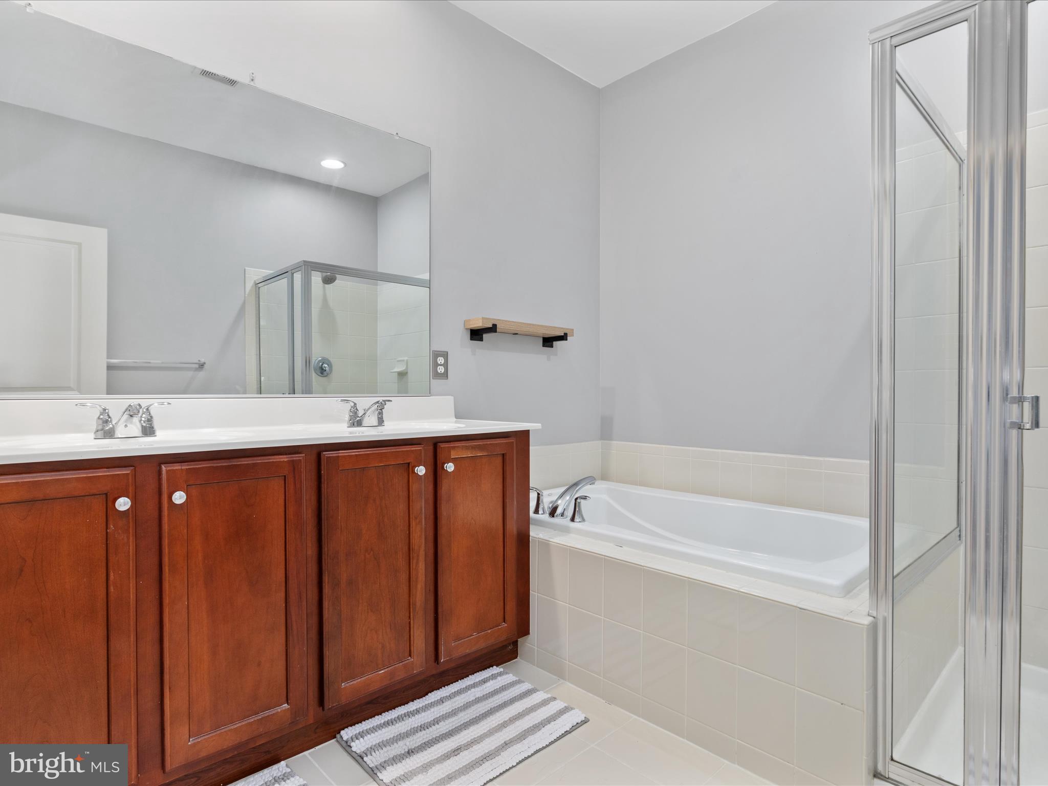 7734 Cedar Branch Drive Gainesville, VA 20155 - Photo 21 of 62 a bathroom with a tub sink and mirror