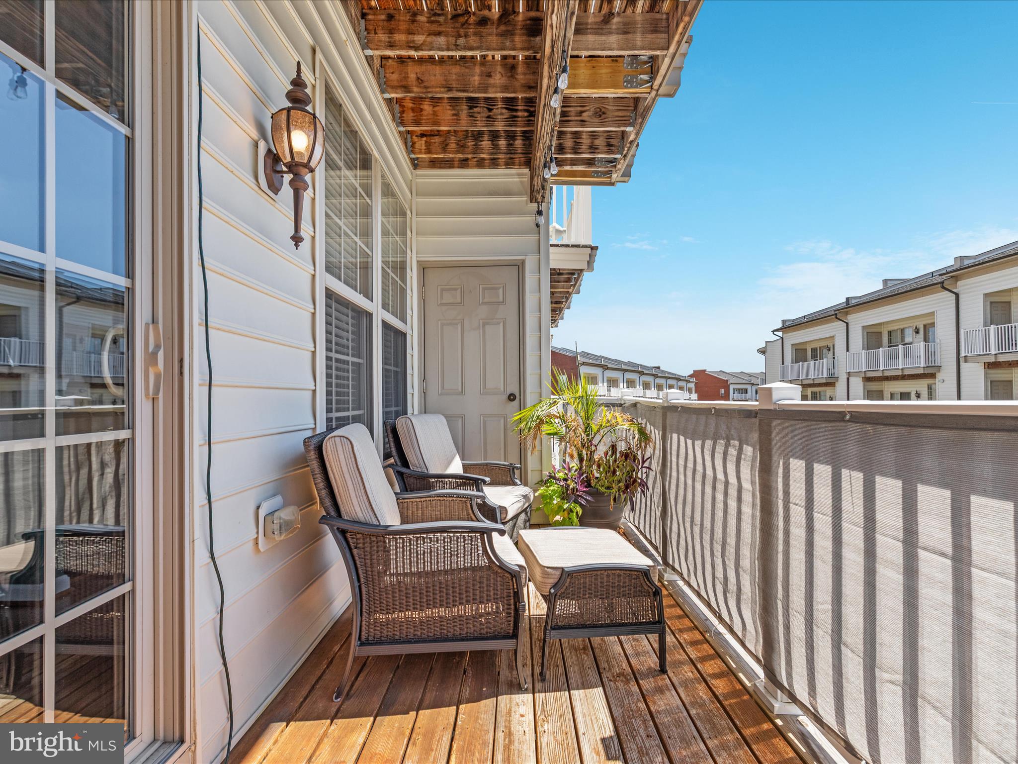 7734 Cedar Branch Drive Gainesville, VA 20155 - Photo 27 of 62 a view of balcony with wooden floor and seating space
