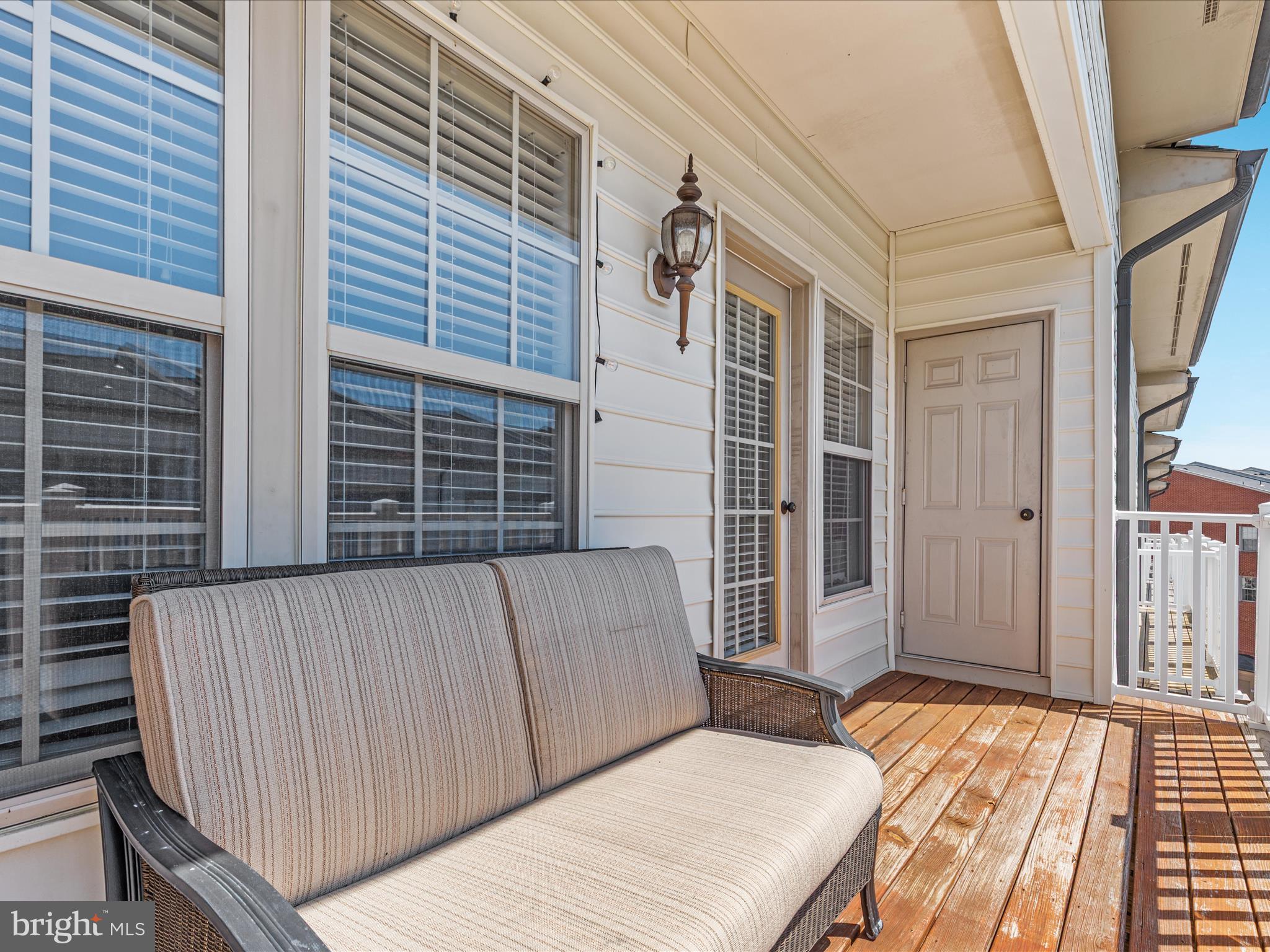 7734 Cedar Branch Drive Gainesville, VA 20155 - Photo 29 of 62 a view of a balcony with wooden floor and fence