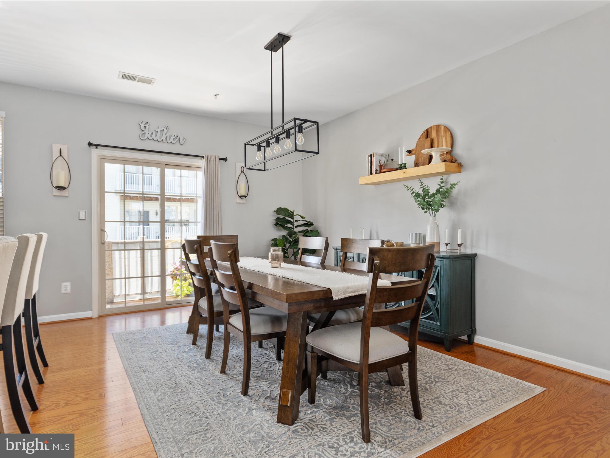 7734 Cedar Branch Drive Gainesville, VA 20155 - Photo 10 of 62 a view of a dining room with furniture window and wooden floor