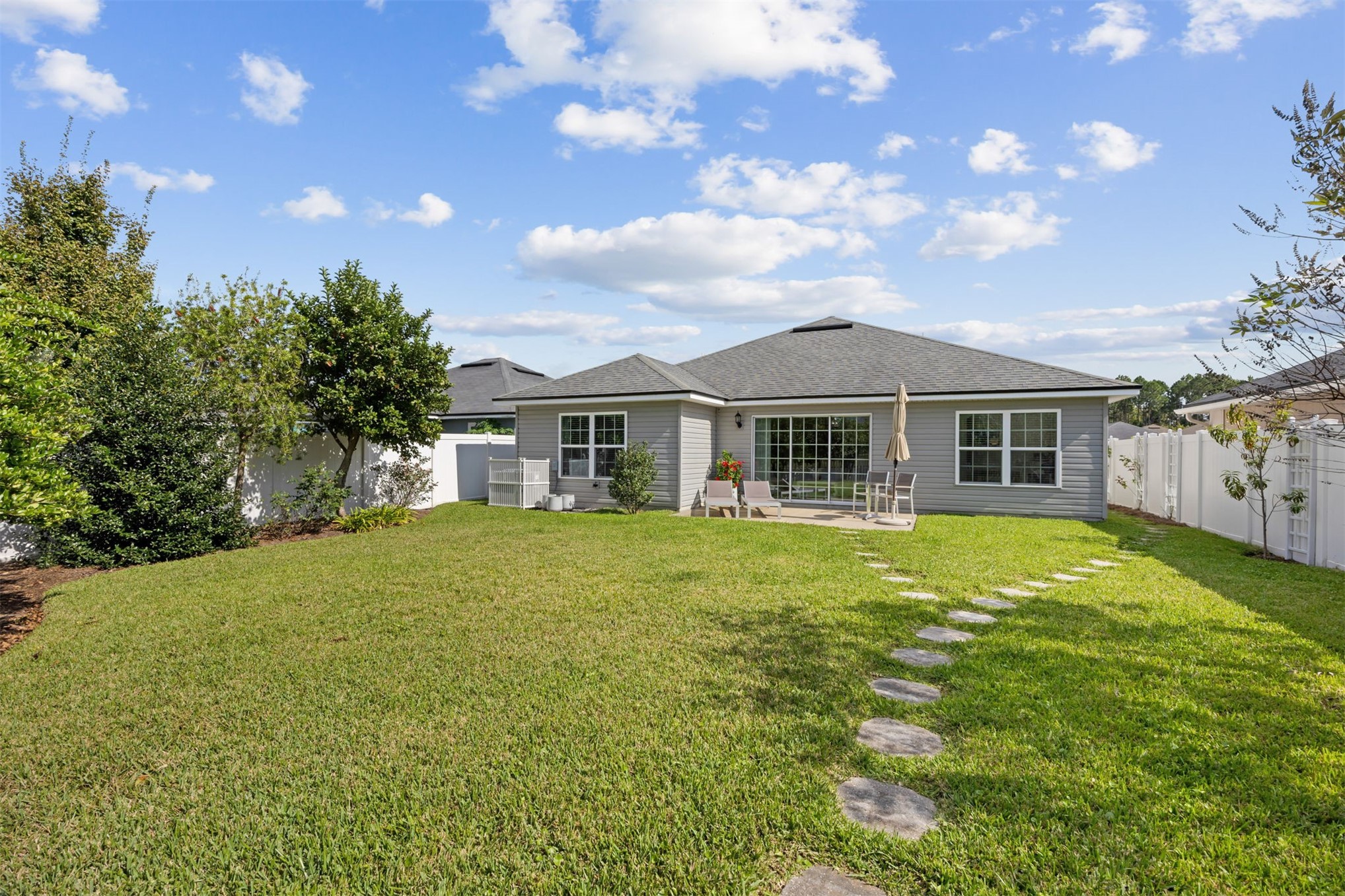 94037 Last Lane Yulee, FL 32097 - Photo 31 of 38 a front view of a house with a garden