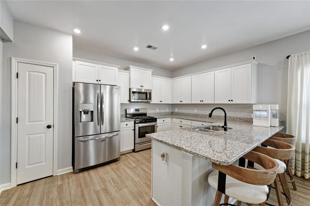 153 Bryon Lane Acworth, GA 30102 - Photo 11 of 25 a kitchen with kitchen island granite countertop appliances cabinets a sink and a counter space