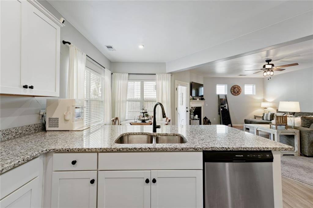 153 Bryon Lane Acworth, GA 30102 - Photo 14 of 25 a kitchen with granite countertop white cabinets and stainless steel appliances