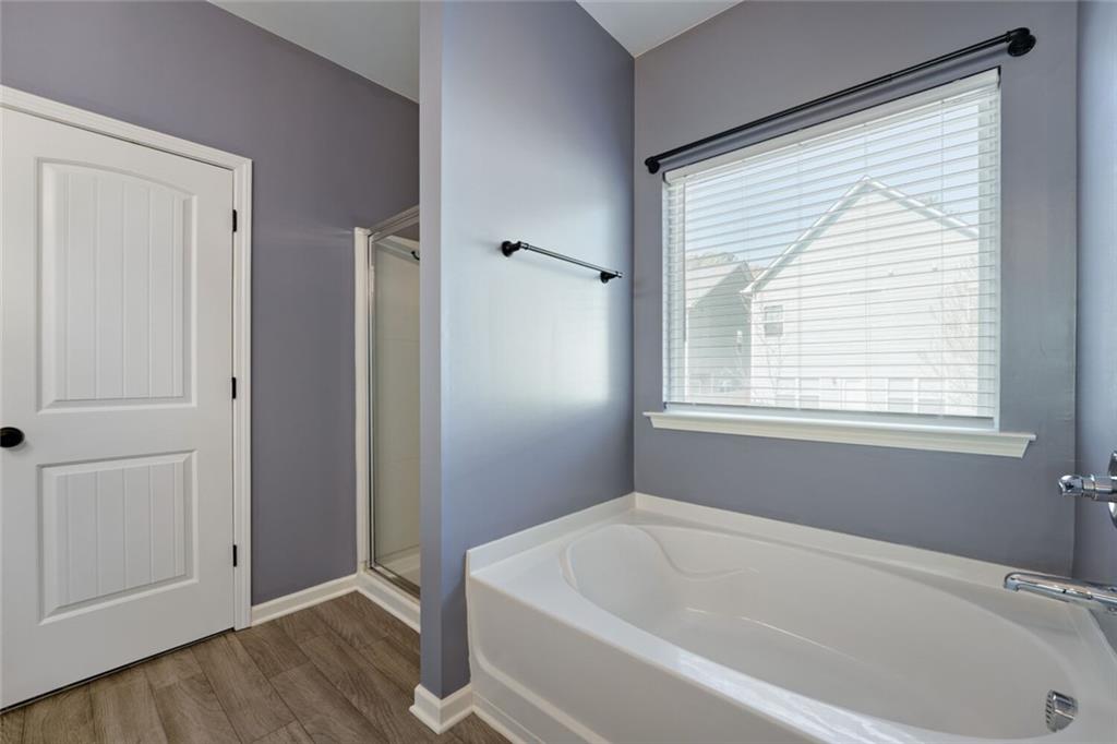 153 Bryon Lane Acworth, GA 30102 - Photo 21 of 25 a white bath tub sitting in a bathroom next to a window