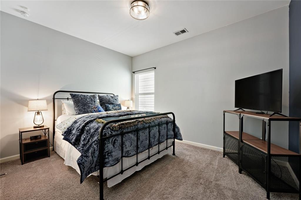 153 Bryon Lane Acworth, GA 30102 - Photo 22 of 25 a bedroom with a bed and a flat screen tv