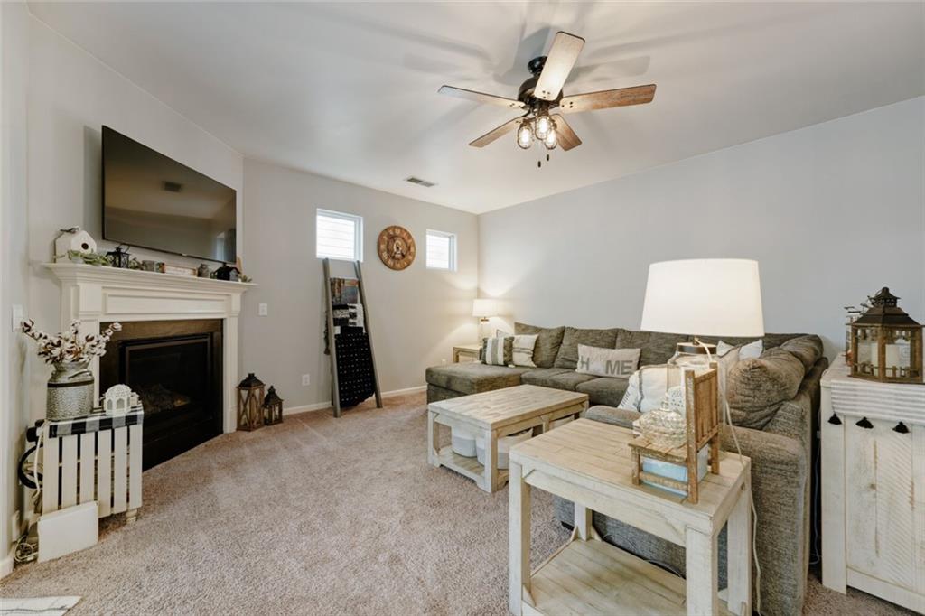 153 Bryon Lane Acworth, GA 30102 - Photo 6 of 25 a living room with furniture a flat screen tv and a fireplace