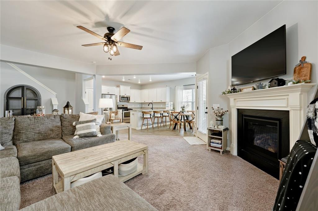 153 Bryon Lane Acworth, GA 30102 - Photo 8 of 25 a living room with furniture a flat screen tv and a fireplace