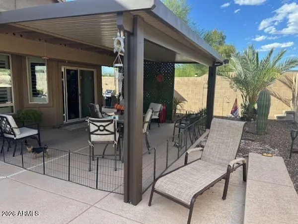 a view of a backyard of a house with table and chairs