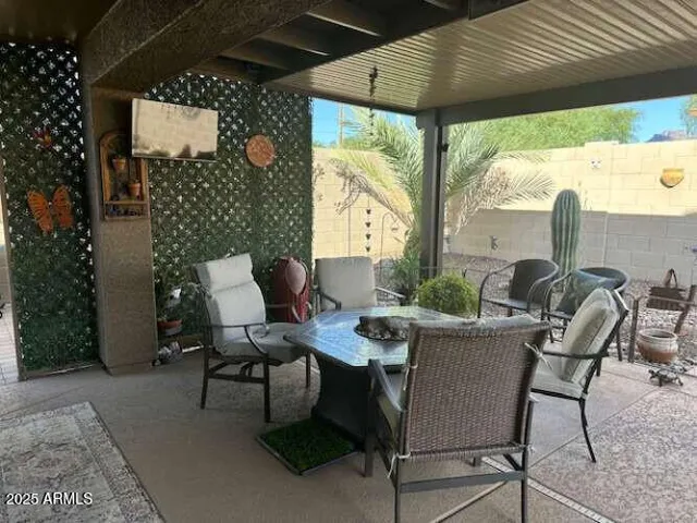 a view of a backyard of a house with table and chairs