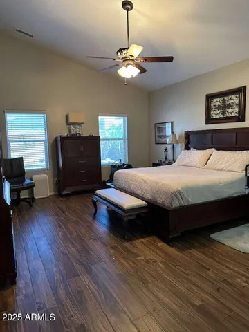 a view of a hallway with wooden floor and cabinet