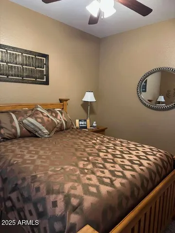 a view of a dining room with furniture a chandelier and wooden floor