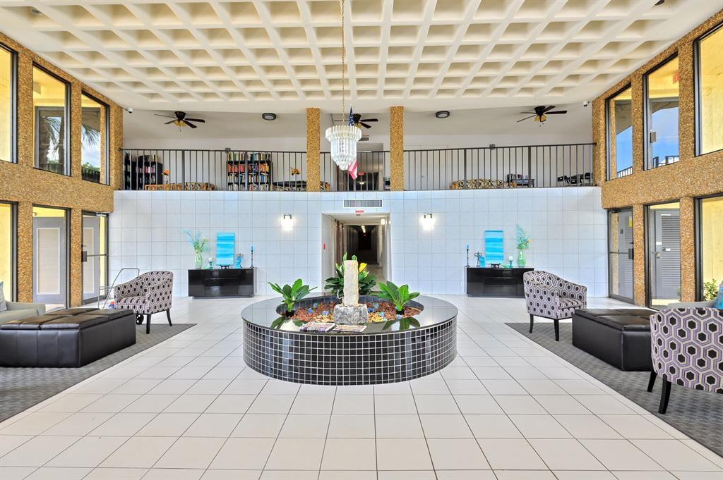 9355 Southwest 8th Street, Unit 401 Boca Raton, FL 33428 - Photo 20 of 37 a living room with furniture and a fireplace