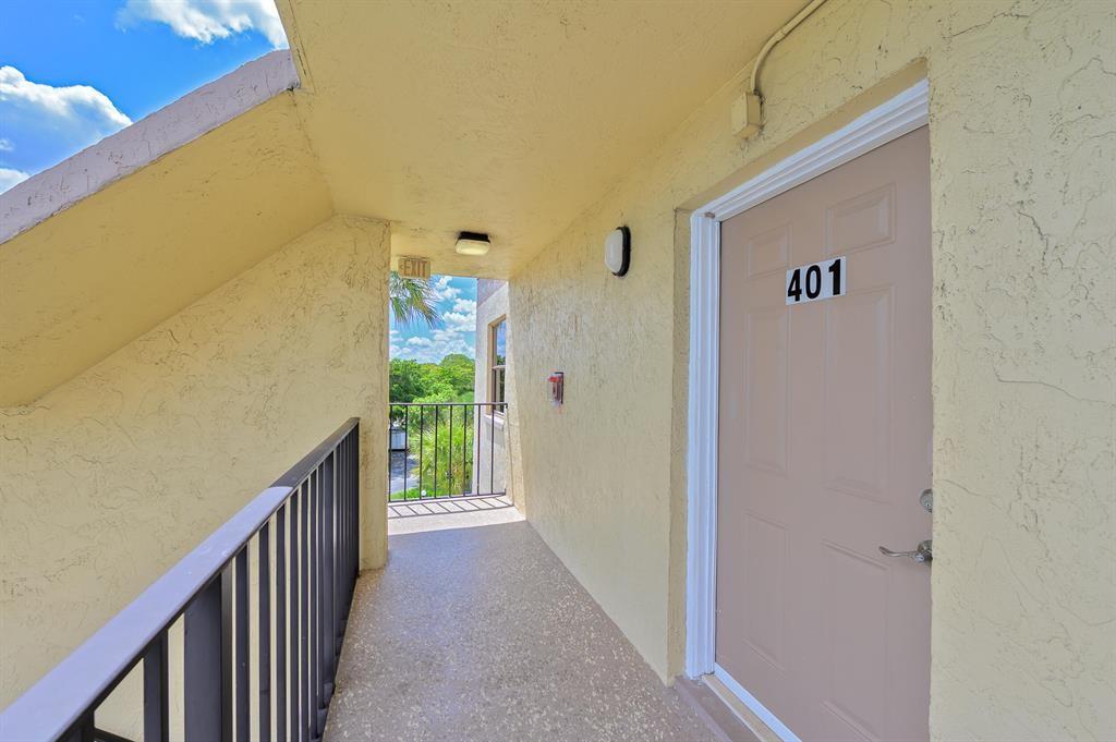 9355 Southwest 8th Street, Unit 401 Boca Raton, FL 33428 - Photo 21 of 37 a view of a hallway to a hallway with windows