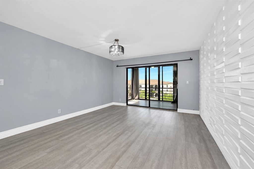 9355 Southwest 8th Street, Unit 401 Boca Raton, FL 33428 - Photo 28 of 37 wooden floor in an empty room with a window