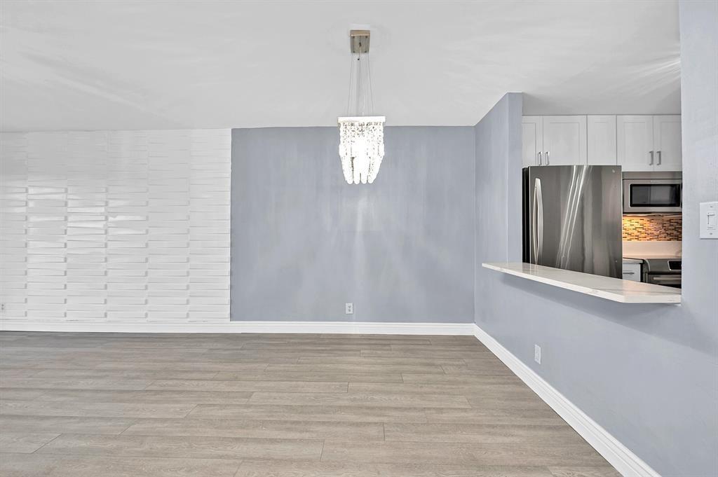 9355 Southwest 8th Street, Unit 401 Boca Raton, FL 33428 - Photo 31 of 37 a view of a kitchen with wooden floor and electronic appliances