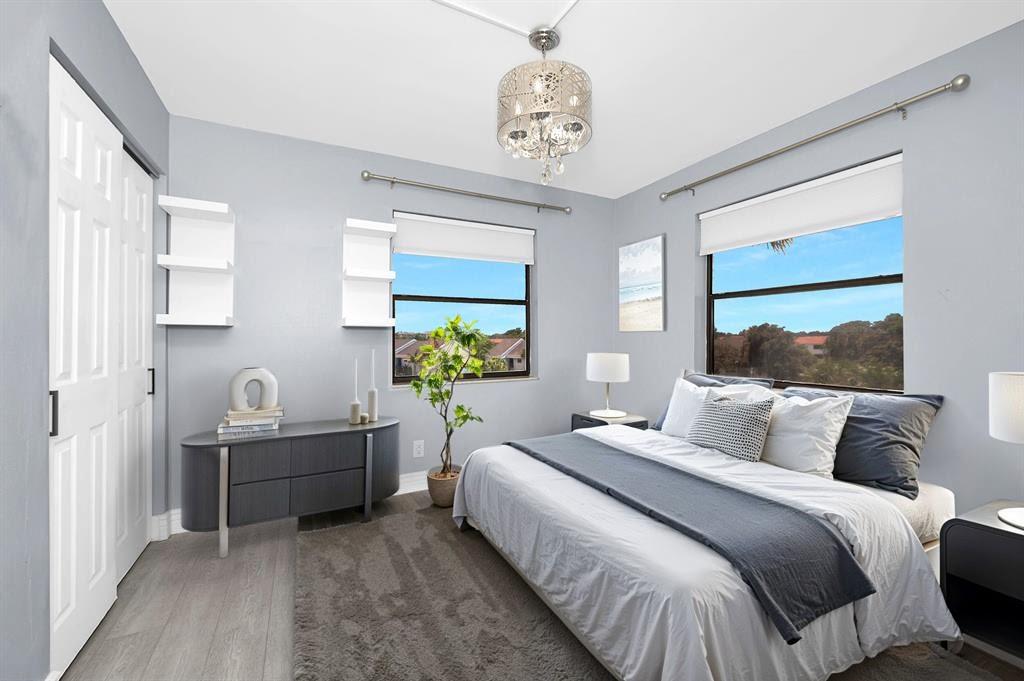 9355 Southwest 8th Street, Unit 401 Boca Raton, FL 33428 - Photo 9 of 37 a bedroom with bed and a window