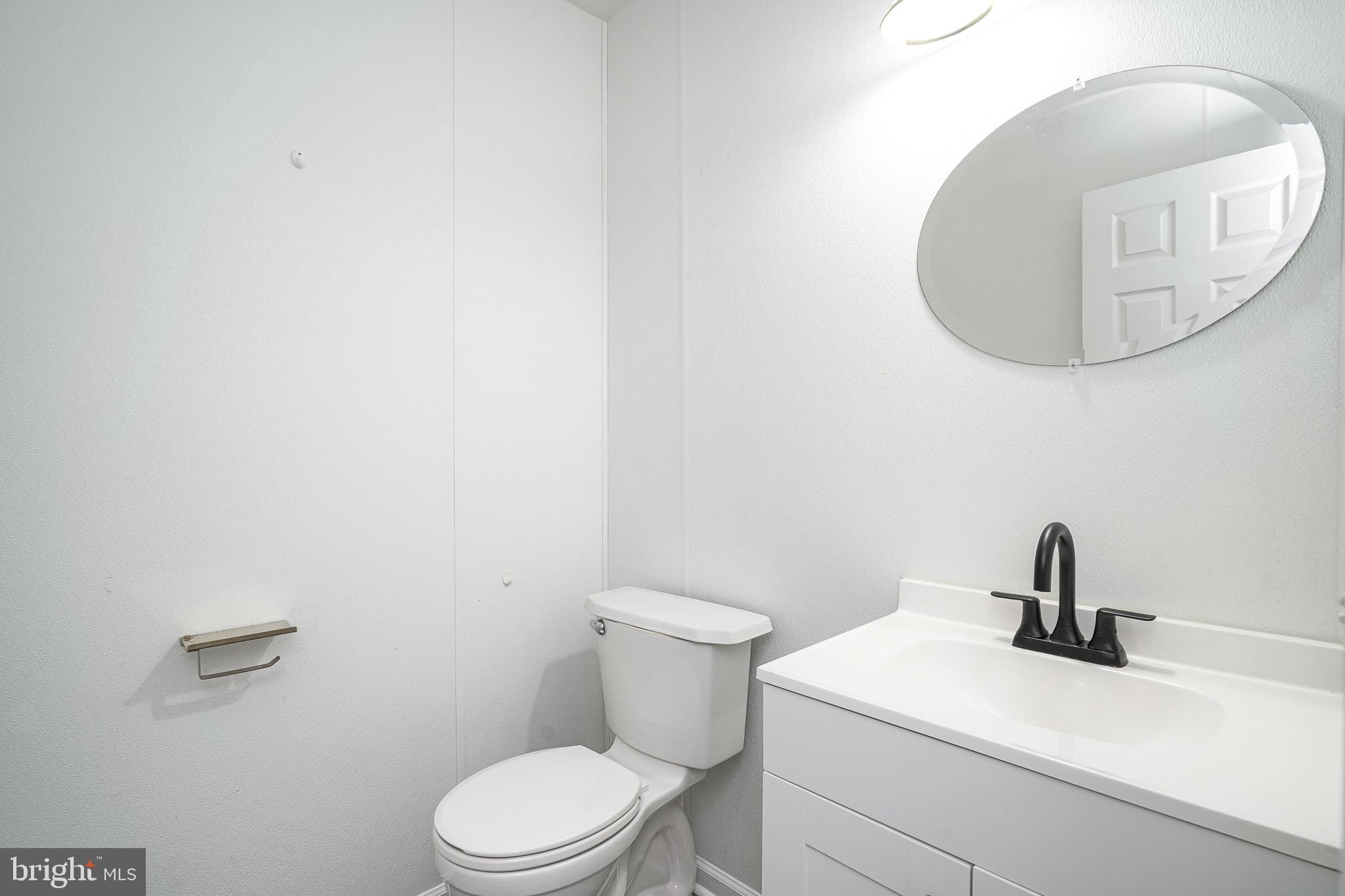 3002 Tall Pines Pine Hill, NJ 08021 - Photo 11 of 29 a bathroom with a toilet sink and mirror