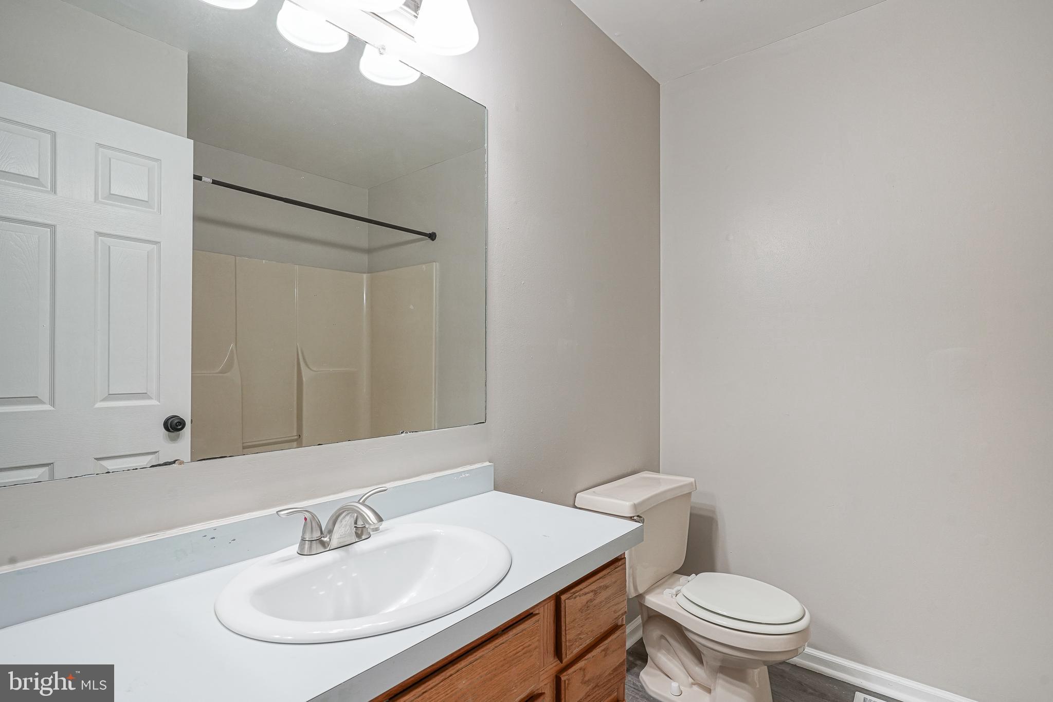 3002 Tall Pines Pine Hill, NJ 08021 - Photo 12 of 29 a bathroom with a sink a toilet and a mirror