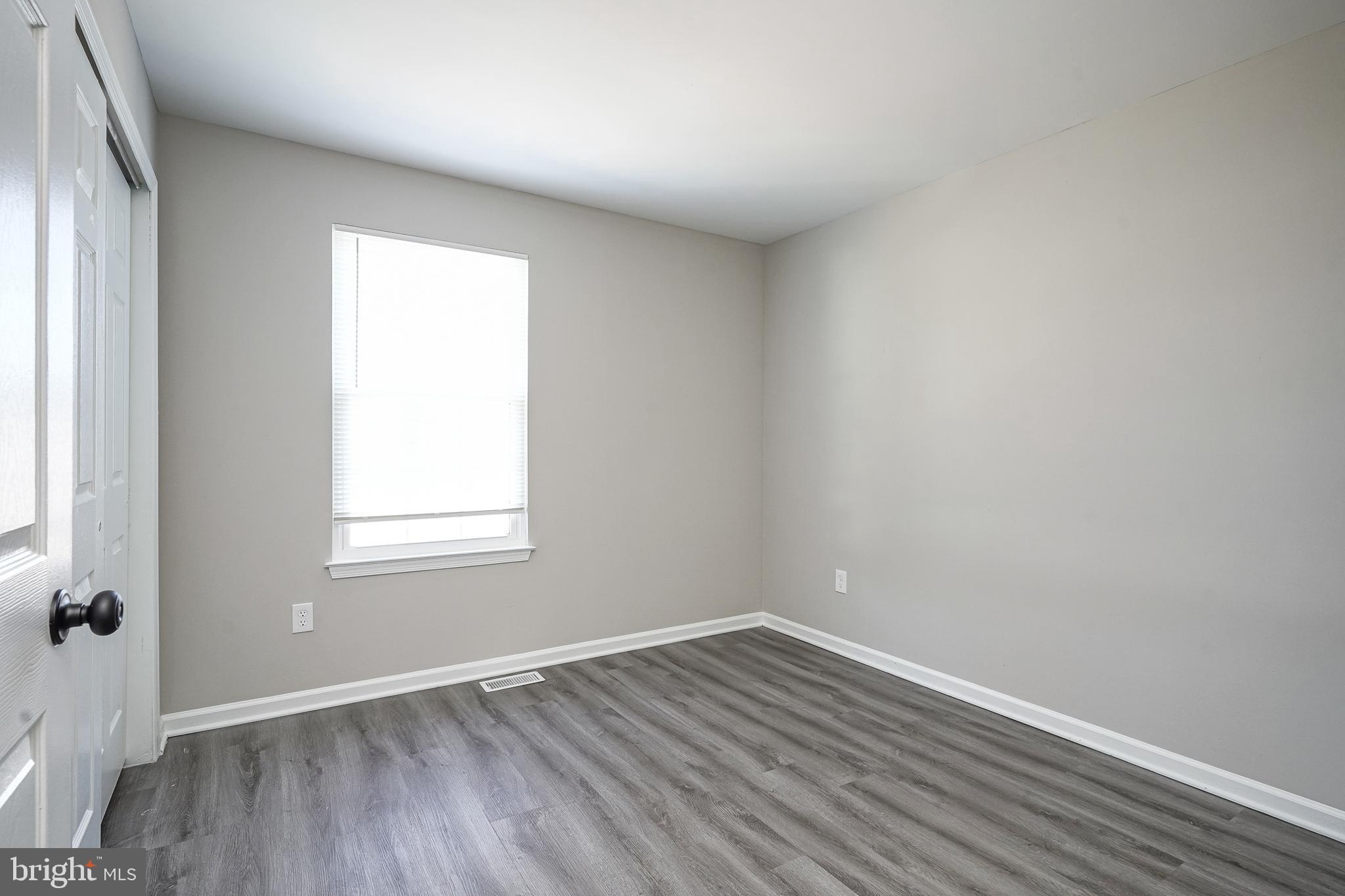 3002 Tall Pines Pine Hill, NJ 08021 - Photo 14 of 29 an empty room with wooden floor and windows