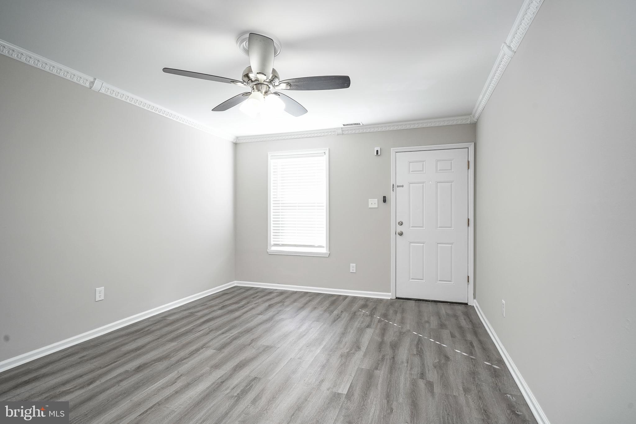 3002 Tall Pines Pine Hill, NJ 08021 - Photo 15 of 29 an empty room with wooden floor fan and windows