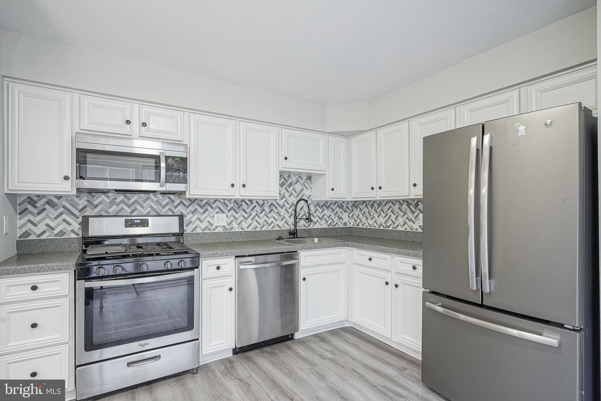 3002 Tall Pines Pine Hill, NJ 08021 - Photo 7 of 29 a kitchen with cabinets stainless steel appliances and wooden floor